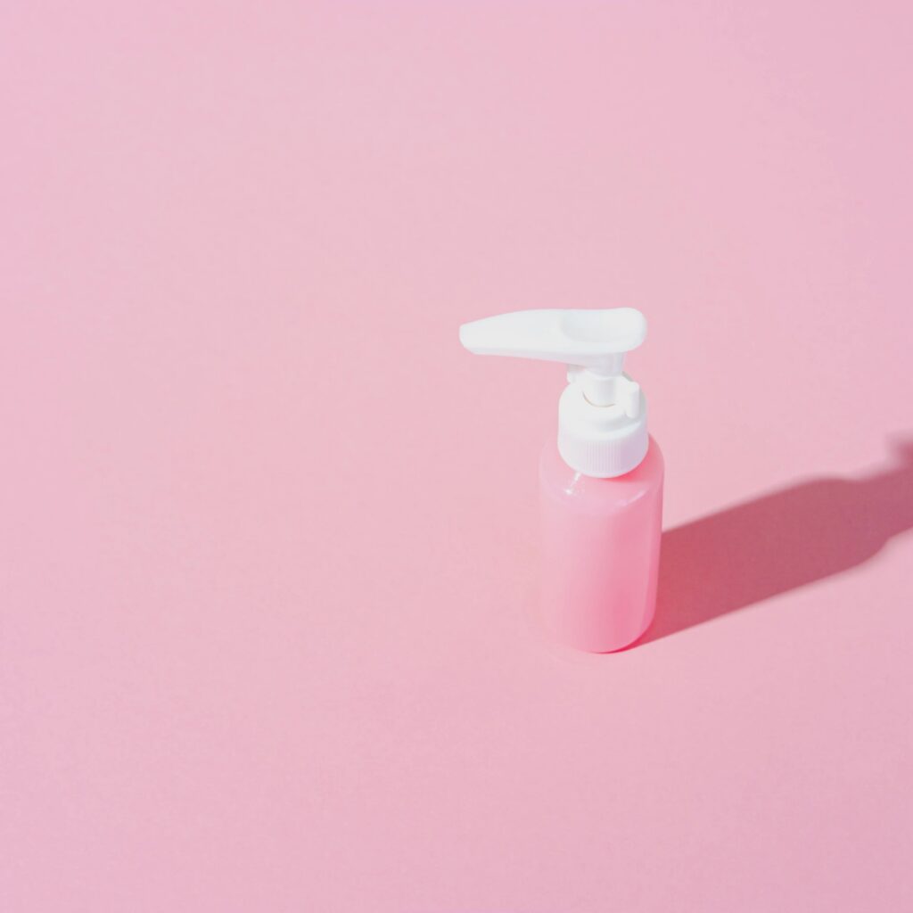 natural cosmetic cream blank bottle. bio organic product on pink background. minimal beauty and spa concept. still life