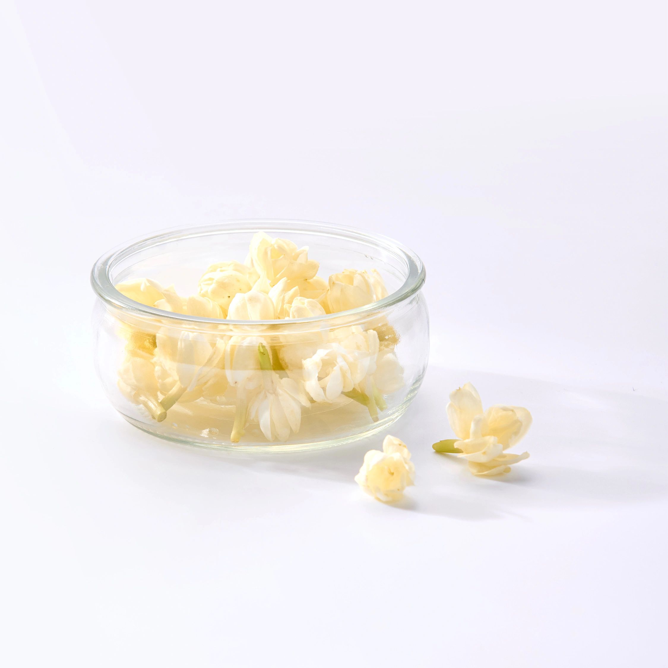White jasmine flowers in a glass bowl